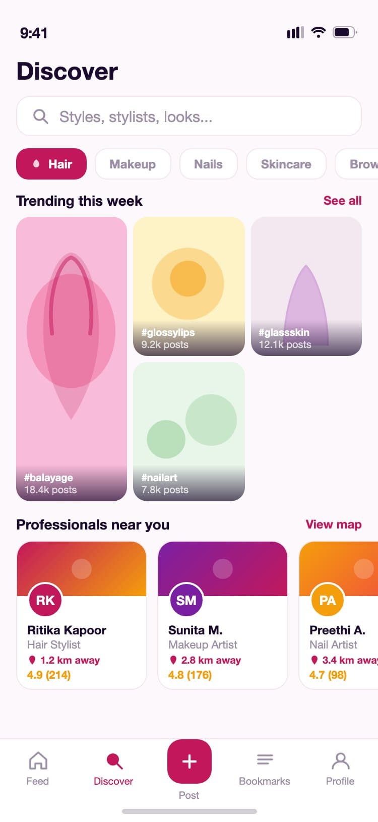 GlamHub discover screen with a search bar, horizontal category chips, a trending hashtag grid showing post counts for balayage and gloss styles, and a Professionals near you strip with pro cards showing distance and ratings